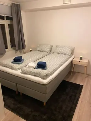 a bedroom with a bed with blue towels on it at 2 Bedroom Apartment Located Downtown Trondheim in Trondheim