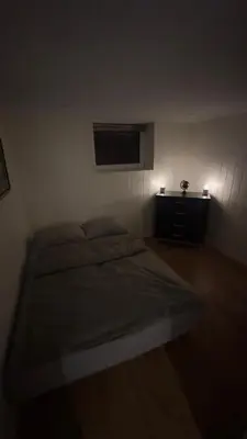 a bedroom with a bed and a tv on the wall at Vassfjellet Home in Trondheim