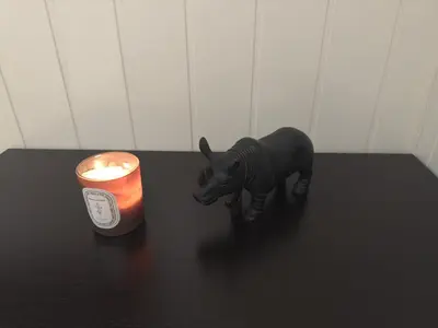 a toy rhino next to a candle on a table at Vassfjellet Home in Trondheim