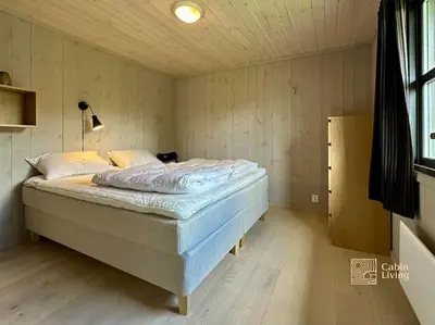 a bedroom with a bed in a room at Modern cabin Skeikampen with ski-in out cross country trails & great view in Aulstad