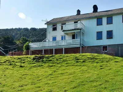 a house on top of a grassy hill at 7 person holiday home in VÅGLAND in Vågland