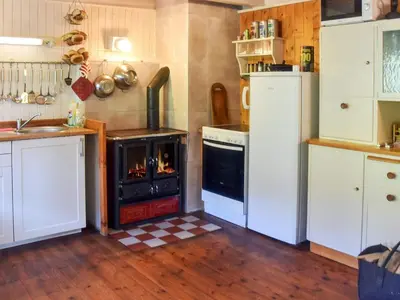 a kitchen with a stove and a oven in it at 7 person holiday home in VÅGLAND in Vågland