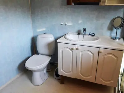 a bathroom with a toilet and a sink at 7 person holiday home in VÅGLAND in Vågland
