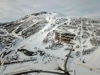 a snow covered mountain with a ski slope at Hovden Alpin Lodge! Ski in out in Hovden