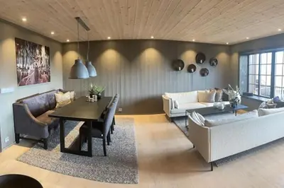 a living room with a couch and a table at Hovden Alpin Lodge! Ski in out in Hovden