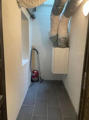 a hallway of a room with a wall and a vacuum at Hovden Alpin Lodge! Ski in out in Hovden