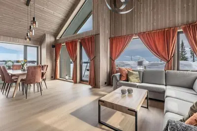 a living room with a couch and a table at Ny moderne hytte i Aust-Torpa in Aust-Torpa