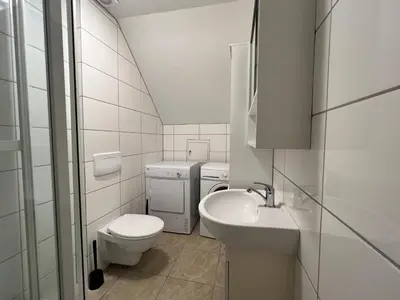 a white bathroom with a toilet and a sink at Bendixens vei 57 in Bergen