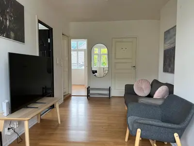 a living room with a couch and a tv at Bendixens vei 57 in Bergen