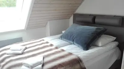 a bedroom with a large bed with towels on it at Voss- Myrkdalen Lodge in Vossestrand