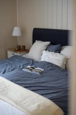 a bed with two books on top of it at Skoglund privat Villa in Trysil