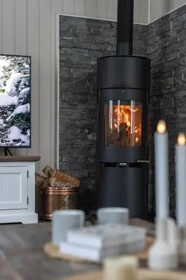 a living room with a fireplace with a tv at Skoglund privat Villa in Trysil