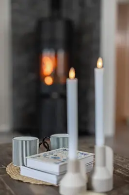 a table with books and candles on a table at Skoglund privat Villa in Trysil