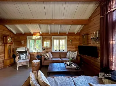 a living room with a couch and a table at Log cabin in Hafjell with ski in ski out, sauna and view in Hafjell