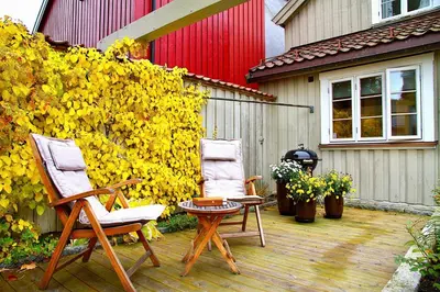 two chairs and a table on a patio at Villa Paradiso, Cathedral View & Parking in Trondheim