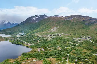 an aerial view of a small town on the side of a mountain at Moderne hytte på Fjellsætra med Jacuzzi in Sykkylven