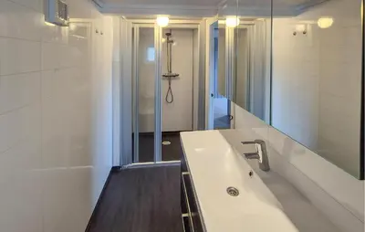 a bathroom with a tub and a sink and a mirror at 3 Bedroom Stunning Home In Omastrand in Sanddal
