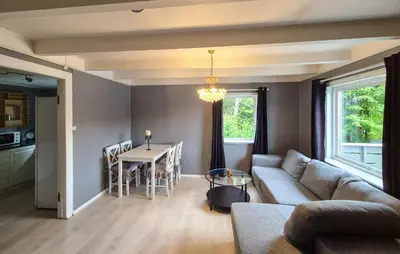 a living room with a couch and a table at 3 Bedroom Stunning Home In Omastrand in Sanddal