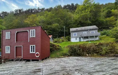 a red house and a white house and a house at 3 Bedroom Stunning Home In Omastrand in Sanddal