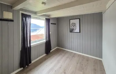an empty room with a window and wooden floors at 3 Bedroom Stunning Home In Omastrand in Sanddal