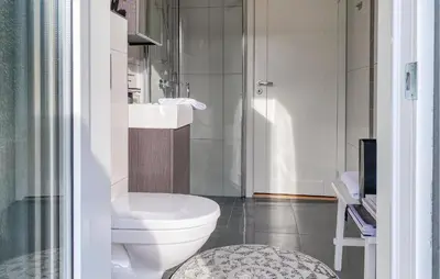 a bathroom with a toilet and a sink and a shower at 3 Bedroom Awesome Home In Nordfjordeid in Nordfjordeid