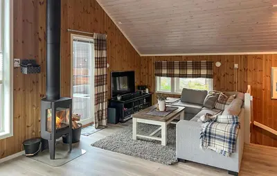 a living room with a couch and a stove at Amazing Home In Oppdal in Oppdal