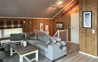 a living room with a couch and a table at Amazing Home In Oppdal in Oppdal