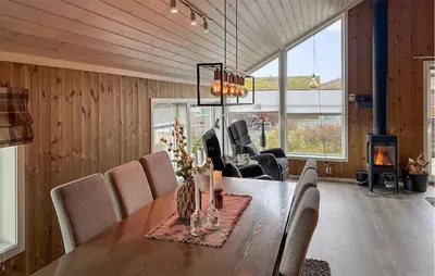 a dining room with a table and chairs and a fireplace at Amazing Home In Oppdal in Oppdal
