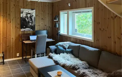 a living room with a couch and a desk at Amazing Home In Oppdal in Oppdal