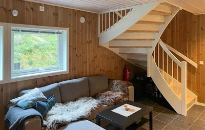 a living room with a couch and a staircase at Amazing Home In Oppdal in Oppdal