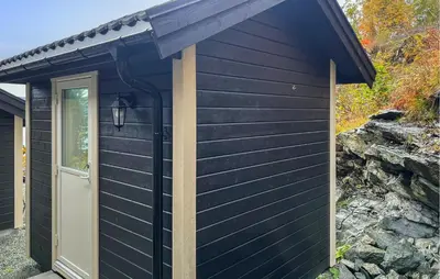 a black shed with a white door and a door at 4 Bedroom Gorgeous Home In Bjugn in Moen
