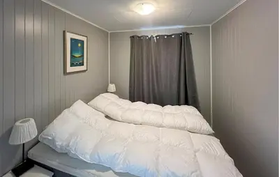 a bed with pillows on it in a bedroom at 4 Bedroom Gorgeous Home In Bjugn in Moen