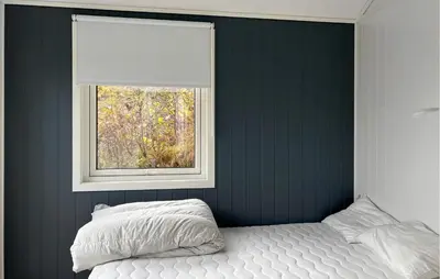 a bedroom with a bed and a window at 4 Bedroom Gorgeous Home In Bjugn in Moen