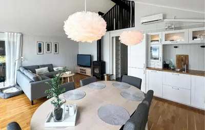 a living room with a table and a couch at 4 Bedroom Gorgeous Home In Bjugn in Moen