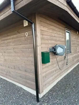 a building with a security camera on the side of it at Hytte v Farstadsanden Anders sandvigsvei 9 in Julshamn
