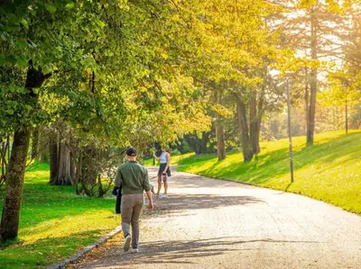 two people walking down a path in a park at Stor leilighet i Bergen sentrum! in Bergen