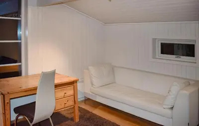 a room with a desk and a couch and a table at Stunning Home In Trysil With Sauna in Trysil