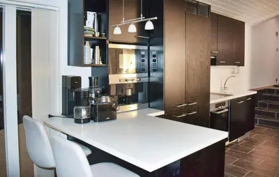 a kitchen with a white counter and some brown cabinets at Stunning Home In Trysil With Sauna in Trysil