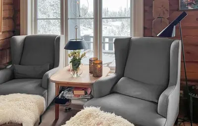 two chairs in a living room with a table at Awesome Home In Sjusjøen With Sauna in Sjusjøen
