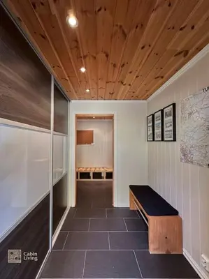 a room with a bench in the middle of a room at Luxury cabin Sjusjøen with hot tub, ski in-out, fireplace & WiFi in Ringsaker