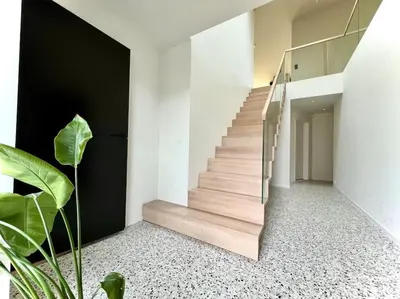 a staircase in a house with a plant at Unik funkisbolig leies ut til ski-VM in Lund