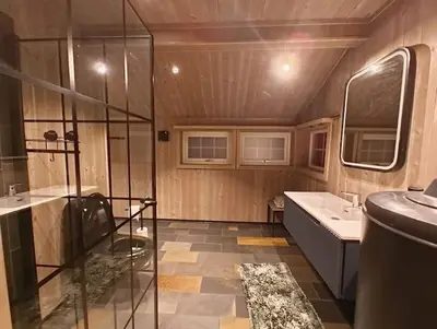 a bathroom with a shower and a tub and a sink at OlaHytta - Cozy cabin close to kvitfjell in Tromsnes