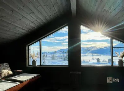 a window in a room with a view of snow covered mountains at Modern cabin at Høgevarde panoramic view, fireplace and EV station in Granheim