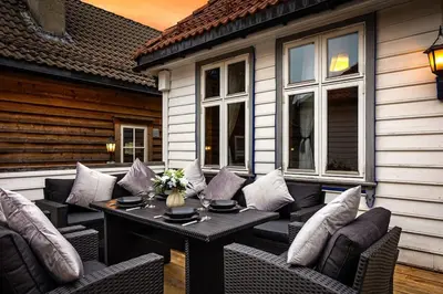 a patio with a table and chairs on a house at Central stay apartment - 301 in Bergen