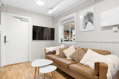 a living room with a couch and a table at Central stay apartment - 301 in Bergen