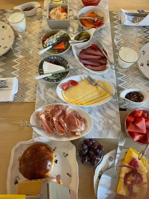 a table with many plates of food on it at Brygga B&B Trondheim sentrum, privat rom i vårt hjem in Trondheim