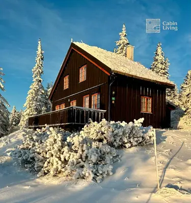 a log cabin in the snow with snow at Original Olympic cabin ski in out Hafjell in Hunder