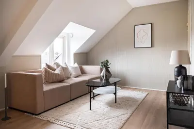 a living room with a couch and a table at Super Central renovated flat, next to Solsiden, Free Private Parking right outside ! in Trondheim
