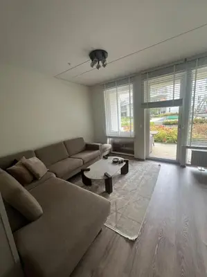 a living room with a couch and a table at SKI VM - Trondheim 2025 in Heimdal