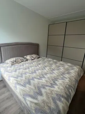 a bedroom with a large bed with a wooden floor at SKI VM - Trondheim 2025 in Heimdal